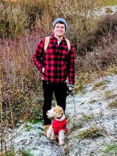 David Osborne on a frosty path with Cleo, a wire fox terrier in a red jumper